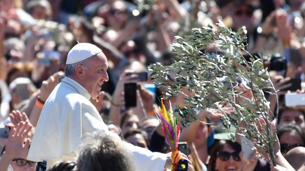 Pope Francis greets the crowd at the end of the Palm Sunday mass at St Peter's square in Vatican. Palm Sunday is the final Sunday of Lent, the beginning of the Holy Week, and commemorates the triumphant arrival of Jesus Christ in Jerusalem, days before he was crucified. (Alberto Pizzoli/AFP)