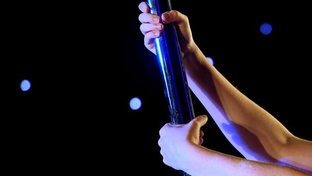 Despite traditionally being associated with raunchy routines, pole dancing is becoming more and more popular as a form of exercise. (Mark RALSTON / AFP)