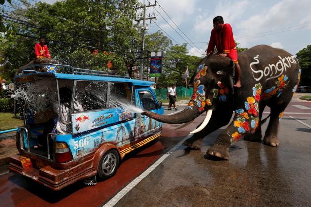 An elephant sprays tourists with water in celebration of the Songkran Water Festival in Ayutthaya province, north of Bangkok, Thailand. (Chaiwat Subprasom / Reuters)