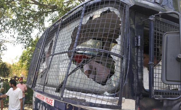 A police bus damaged by students protesting against the fee hike at Panjab University in Chandigarh on Tuesday, April 11. At least 15 policemen and some students had to get medical help; some were still in hospitals and said to be in a stable state. More than 50 were taken into custody. (Karun Sharma/HT)