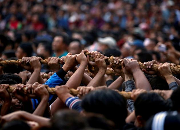 During the celebrations, a three-storey wooden chariot carrying the revered idol of Bhairab is pulled through the narrow streets by local men, before a huge tree trunk is erected – representing the union of man and woman. (Navesh Chitrakar/REUTERS)