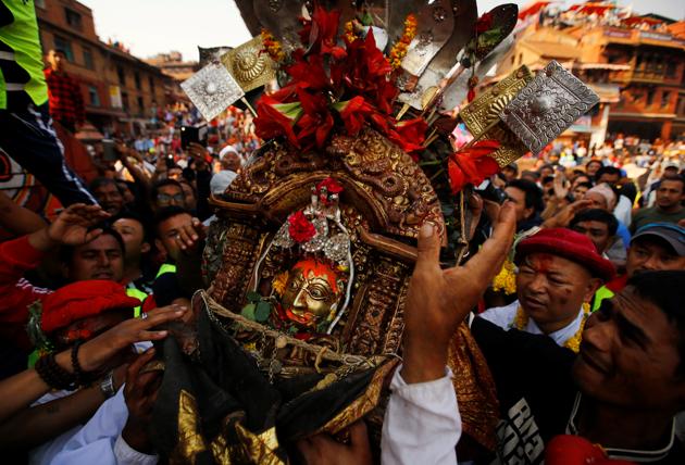 Devotees carry the idol of God Bhairab towards the chariot. (Navesh Chitrakar/REUTERS)