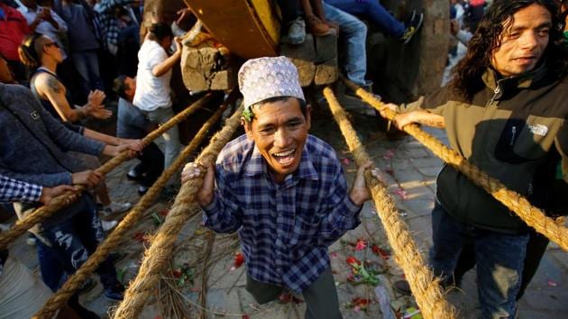 A devotee holds on to the ropes tied to the chariot of God Bhairab during the Biska Festival also known as Bisket festival in Bhaktapur, Nepal. (Navesh Chitrakar/REUTERS)