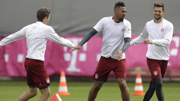 Bayern Munich's Jerome Boateng, center, goalkeeper Sven Ulreich, right, and Thomas Mueller warm up ahead of their UEFA Champions League clash against Real Madrid.(AP)