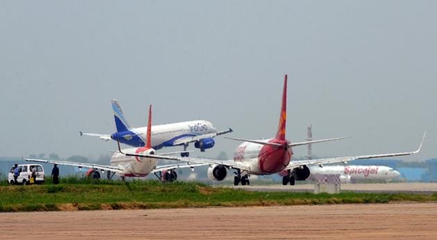 Aircraft from Indigo (C), Air India (L) and Spicejet (R) jostle for space on a runway at Indira Gandhi International Airport in New Delhi.(AFP)