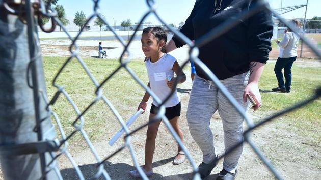 The girl, Marissa Perez, and her mother, Elizabeth Barajas, cried and hugged as they reunited several hours after Monday’s shooting. (Frederic J. Brown/AFP) The girl, Marissa Perez, and her mother, Elizabeth Barajas, cried and hugged as they reunited several hours after Monday’s shooting. (Frederic J. Brown/AFP)