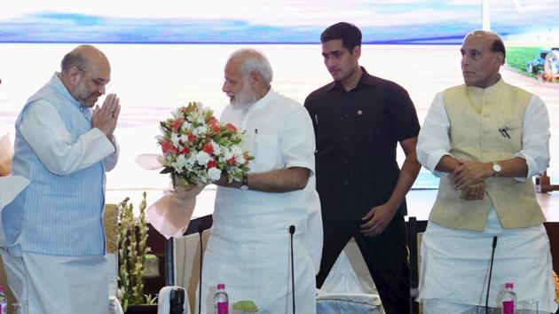 Prime Minister Narendra Modi being greeted by BJP President Amit Shah as home minister Rajnath Singh looks on at a meeting of National Democratic Alliance in New Delhi on Monday. (PTI) Prime Minister Narendra Modi being greeted by BJP President Amit Shah as home minister Rajnath Singh looks on at a meeting of National Democratic Alliance in New Delhi on Monday. (PTI)