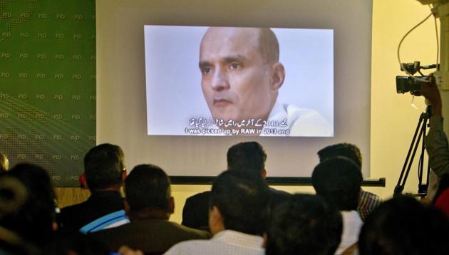 In this March 29, 2016 photo, journalists look at an image of Indian naval officer Kulbhushan Jadhav, who was arrested in March 2016, during a press conference by Pakistan's army spokesman and the Information Minister, in Islamabad, Pakistan.(AP Photo)