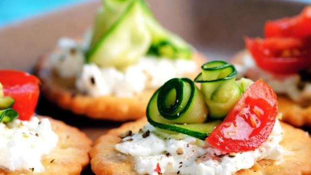 Bite-size canapes with sour cream, zucchini or cucumber and tomato.(Getty Images/iStockphoto)
