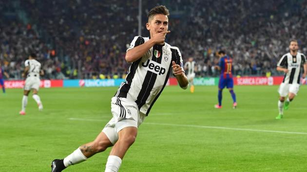 Juventus F.C.'s forward Paulo Dybala celebrates after scoring during the UEFA Champions League quarterfinal first leg match against FC Barcelona on Tuesday.(AFP)