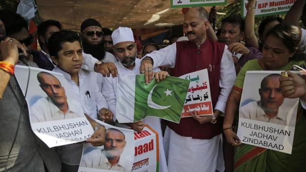 Members of Bharatiya Janata Party Minority Morcha burn a Pakistani flag during a protest against the conviction of a retired Indian naval officer Kulbhushan Jadhav, in Mumbai on Wednesday. (AP) Members of Bharatiya Janata Party Minority Morcha burn a Pakistani flag during a protest against the conviction of a retired Indian naval officer Kulbhushan Jadhav, in Mumbai on Wednesday. (AP)