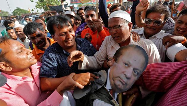 People beat an effigy of Pakistan's Prime Minister Nawaz Sharif during a protest against the death sentence of Kulbhushan Jadhav, in Lucknow. (REUTERS) People beat an effigy of Pakistan's Prime Minister Nawaz Sharif during a protest against the death sentence of Kulbhushan Jadhav, in Lucknow. (REUTERS)