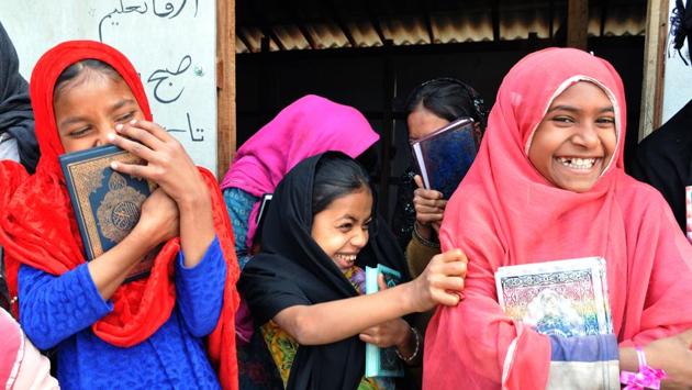 Rohingya Muslim girls reacts to camera as they wait for their teacher outside the Madrasa. The Rohingya Muslim migrants are a stateless ethnic group persecuted by Myanmar’s Buddhist majority. (Nitin Kanotra/HT Photo)