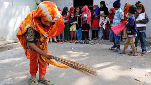 A Rohingya Muslim girl cleaning the outer part of Madrasa. They were forced out since a bloody crackdown by the army in their home state of Rakhine in the 1980s. (Nitin Kanotra/HT Photo)