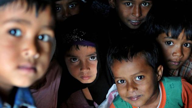 Rohingya Muslim children from Myanmar look on as they play at a refugee camp on the outskirts of Jammu. They have entered into the Jammu and Kashmir state illegally through either Indo-Bangladesh border, Indo-Myanmar border or travelling through the Bay of Bengal. There are about 40,000 Rohingya Muslims living in different parts of the country. (Nitin Kanotra/HT Photo)