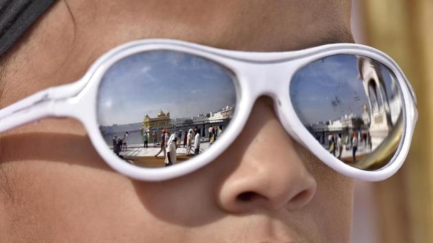 A view of Golden temple displayed on the sunglasses of a devotee at Golden Temple, Amritsar. (Gurpreet Singh/ HT Photo)
