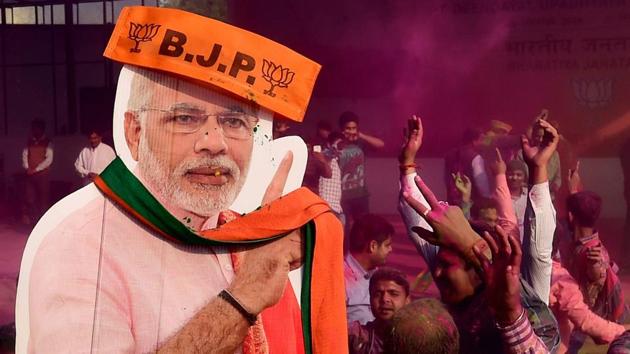 BJP workers play holi with a giant cut-out of Prime Minister Narendra Modi as they celebrate the party’s victory in the UP and Uttarakhand Assembly elections, at the party headquarters in New Delhi on March 11.(PTI) BJP workers play holi with a giant cut-out of Prime Minister Narendra Modi as they celebrate the party’s victory in the UP and Uttarakhand Assembly elections, at the party headquarters in New Delhi on March 11.(PTI)