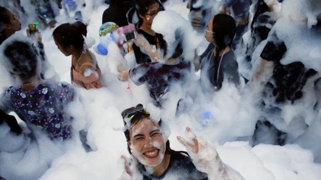 A reveller reacts at a foam party during Songkran Festival celebrations. The festival is by far the most important event of the year for the Thai people. (REUTERS)