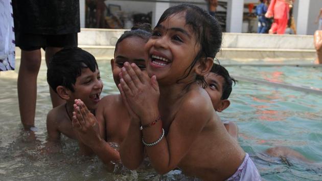 Children taking holy dip in sarovar (water tank) at gurdwara Shaheed Baba Nihal Singh in village Talhan on the out skirts of Jalandhar. (Pradeep Pandit/HT Photo) 