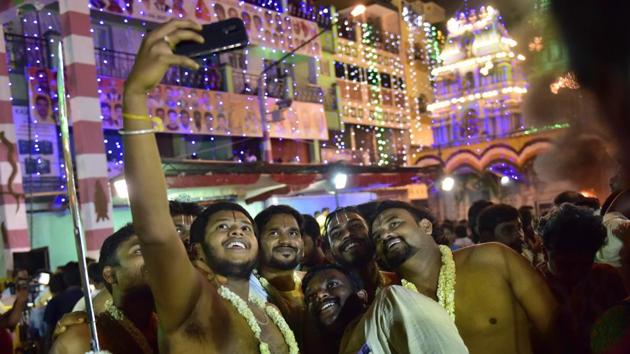 Devotees take selfies outside the Dharmaraya Swamy Temple in Bengaluru. (Arijit Sen/HT Photo) Devotees take selfies outside the Dharmaraya Swamy Temple in Bengaluru. (Arijit Sen/HT Photo)