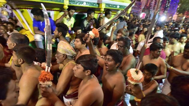 Youngsters inside the temple with customary swords on the occasion of Karaga at Dharmaraya Swamy Temple in Bengaluru. (Arijit Sen/HT Photo) Youngsters inside the temple with customary swords on the occasion of Karaga at Dharmaraya Swamy Temple in Bengaluru. (Arijit Sen/HT Photo)