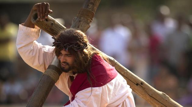 A Christian devotee re-enacts the crucifixion of Jesus Christ . (Mahesh Kumar A./ AP)