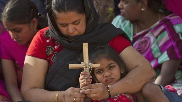 An Indian mother and daughter pray as they watch the re-enacting of the crucifixion of Jesus Christ during Good Friday in Hyderabad, India. (Mahesh Kumar / AP)