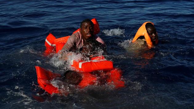Migrants try to stay afloat after falling off their rubber dinghy. (Darrin Zammit Lupi / Reuters) Migrants try to stay afloat after falling off their rubber dinghy. (Darrin Zammit Lupi / Reuters)