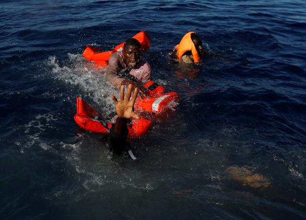 Migrants try to stay afloat after falling off their rubber dinghy during a rescue operation by the Malta-based NGO Migrant Offshore Aid Station (MOAS) ship in the central Mediterranean in international waters some 15 nautical miles off the coast of Zawiya in Libya. (Darrin Zammit Lupi / Reuters) Migrants try to stay afloat after falling off their rubber dinghy during a rescue operation by the Malta-based NGO Migrant Offshore Aid Station (MOAS) ship in the central Mediterranean in international waters some 15 nautical miles off the coast of Zawiya in Libya. (Darrin Zammit Lupi / Reuters)