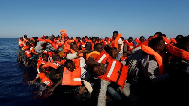 Migrants fall off their rubber dinghy during a rescue operation by the Malta-based NGO Migrant Offshore Aid Station (MOAS) ship. (Darrin Zammit Lupi / Reuters) Migrants fall off their rubber dinghy during a rescue operation by the Malta-based NGO Migrant Offshore Aid Station (MOAS) ship. (Darrin Zammit Lupi / Reuters)
