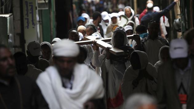 Christian pilgrims carry a wooden cross along the Via Dolorosa (Way of Suffering) in Jerusalem’s Old City during the Good Friday procession. Christians around the world observe Good Friday as the day when Jesus Christ died on the cross for humanity so that he could save them from their sins. (Thomas Coex/AFP)