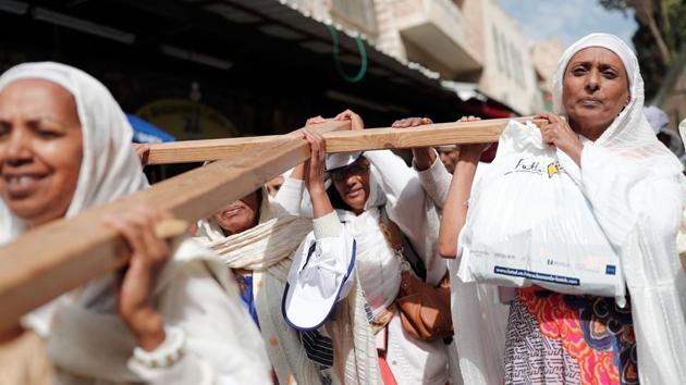Christian pilgrims carry a wooden cross along the Via Dolorosa (Way of Suffering) in Jerusalem’s Old City during the Good Friday procession. For Christians, it is the most sorrowful, sombre and sacred day of the year. It is also referred as Holy Friday, Great Friday, Black Friday, or Easter Friday. (Thomas Coex/AFP)