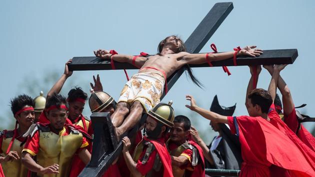 A Philippine Christian devotee reacts in pain while nailed to a cross during a re-enactment of the Crucifixion of Christ. While some say ‘good’ means holy, others say that it is a modification of ‘God Friday.’ (Noel Celis/AFP)
