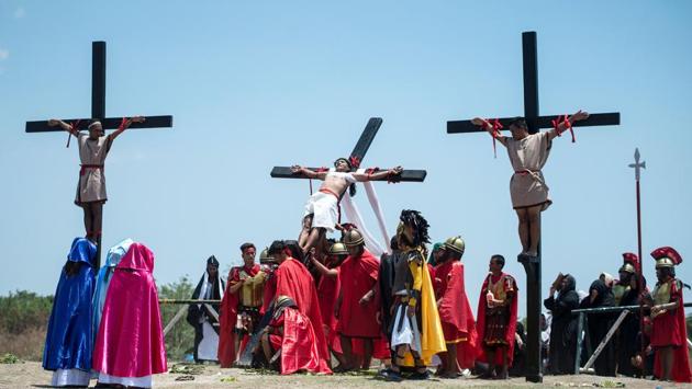 Philippine Christian devotees bring down Ruben Enaje (C) after he was nailed to a cross during a re-enactment of the Crucifixion of Christ. However, many believe it is an appropriate term since it denotes that Christ suffered and died for his people. (Noel Celis/AFP)