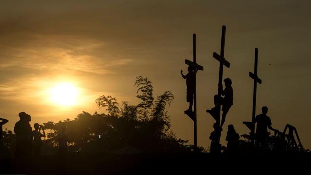 Local tourists pose with the crosses before a re-enactment of the crucifixion of Jesus Christ. Lent represents the time Jesus spent fasting in the desert, before starting his public ministry, where he endured temptation by Satan. (Noel Celis/AFP)
