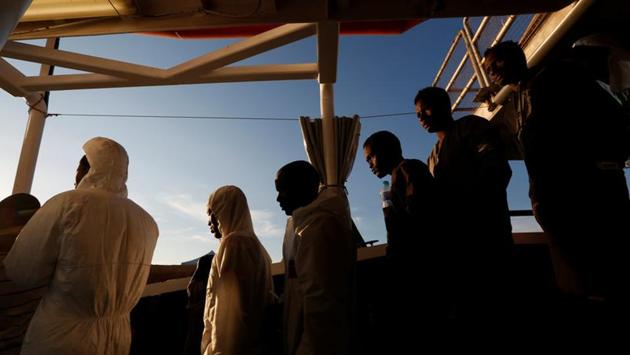 Rescued migrants wait to disembark from the Malta-based NGO Migrant Offshore Aid Station (MOAS) ship Phoenix in Pozzallo on the island of Sicily, Italy. (Darrin Zammit Lupi / Reuters) Rescued migrants wait to disembark from the Malta-based NGO Migrant Offshore Aid Station (MOAS) ship Phoenix in Pozzallo on the island of Sicily, Italy. (Darrin Zammit Lupi / Reuters)
