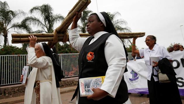 Religious leaders carry a cross during a silent Good Friday march in Durban, South Africa. The etymology of the term ‘good’ in Good Friday is contested in various circles. (Rogan Ward/REUTERS)