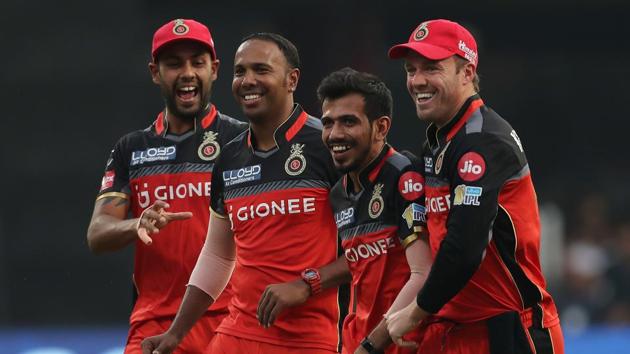 Royal Challengers Bangalore captain Virat Kohli celebrates the dismissal of Mitchell McClenaghan with Samuel Badree.  (BCCI) 