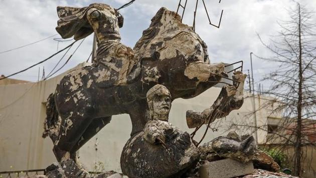 A damaged statue is seen outside a church in the town of Qaraqosh. The town, about 20 km (12 miles) from the battlefront with Islamic State in the northern city of Mosul, shows why Christians have mixed feelings about the future of their ancient community. (Marko Djurica/Reuters)