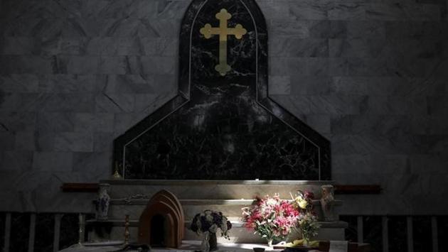 An altar is seen inside a church. Iraqi forces pushed the group out of Qaraqosh in October, part of a six-month offensive to retake Mosul. But residents are worried that the Shi’ite slogans signal a new kind of sectarian division. (Marko Djurica/Reuters)
