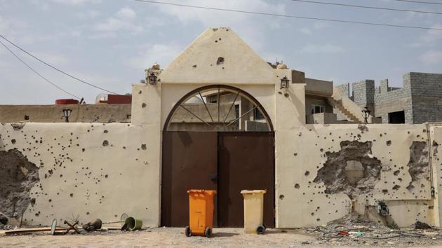 A wall damaged by bullets fired by Islamic State militants is seen inside a church yard. Shi’ites regard Ali, the son-in-law of the Prophet Mohammed, and the prophet’s grandson Hussein as his true successors. (Marko Djurica/Reuters)