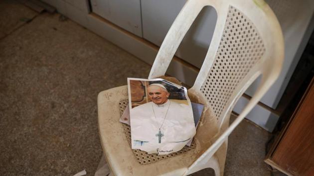 A picture of Pope Francis is seen inside a church. Numbers of Christians in Iraq have fallen from 1.5 million to a few hundred thousand since the violence which followed the 2003 toppling of Saddam Hussein. (Marko Djurica/Reuters)