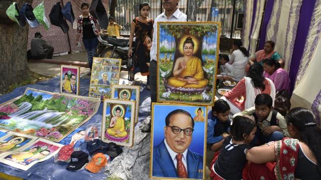 People buy posters and souvenirs in tribute of Dr Bhim Rao Ambedkar at Parliament Street in New Delhi.(Sushil Kumar/HT File Photo)