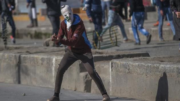 A masked Kashmiri protester prepares to catch a stone during a protest in Srinagar. (AP Photo) A masked Kashmiri protester prepares to catch a stone during a protest in Srinagar. (AP Photo)