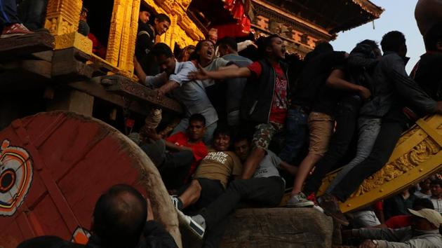 Young men tugging the chariots of Gods through the crowd in from of Nyatapola temple. (Photo By Nipun Prabhakar)