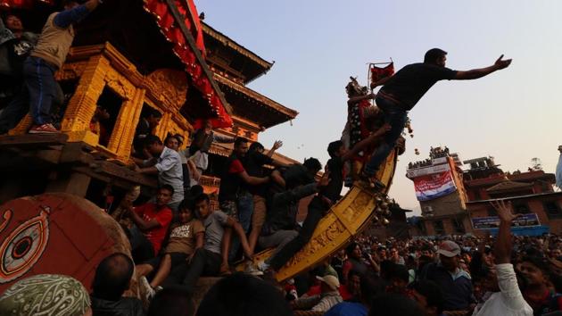 A man on top of the wooden chariot tries to make the way for the Ratha of Bhairav at the Bisket Jatra. (Photo By Nipun Prabhakar)