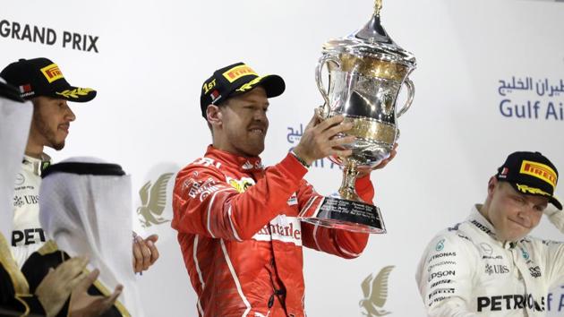 Ferrari driver Sebastian Vettel (centre) celebrates after winning the Bahrain Formula One Grand Prix.(AP)