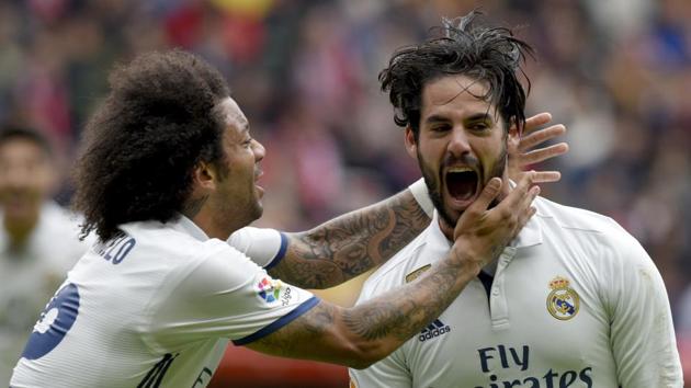 Real Madrid's Isco celebrates with team mate Marcelo after scoring a goal against Sporting Gijon in La Liga.(REUTERS)