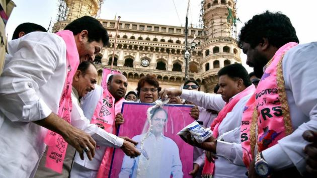 Deputy CM Mohammed Mahmood Ali and Waqf board chairman Mohammed Saleem along with party workers pour milk on a portrait of Telangana chief minister K Chandrashekhar Rao for pushing reservation for Muslims to 12%, at Charminar in Hyderabad on Thursday.(PTI Photo)