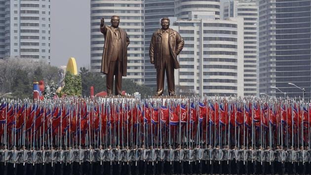 University students carry the national flag and two bronze statues of the late leaders Kim Il Sung and Kim Jong Il during a military parade. (Wong Maye-E / AP)